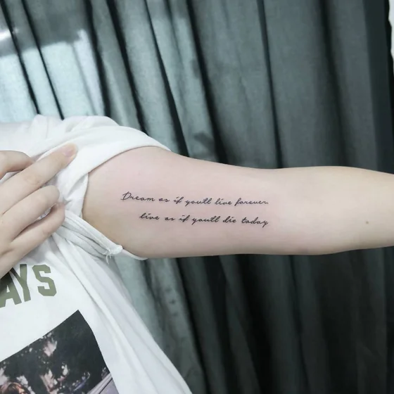 Fine Line Script Quote tattoo idea for women on Upper Arm