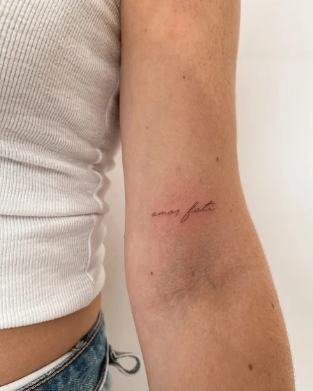 Fine Line Script Quote tattoo idea for women on Upper Arm