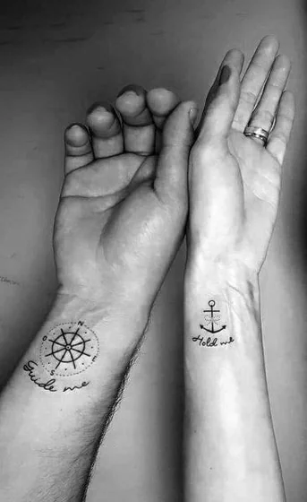 Fine Line Script compass and anchor matching tattoo idea for men and women on wrist