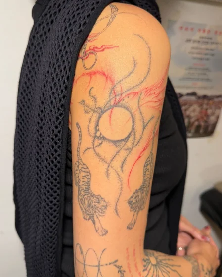 Fine Line Sketch Tiger tattoo idea for women on Upper Arm with Abstract energy