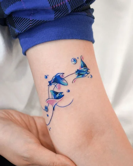 Fine Line Watercolor Manta Ray Ocean tattoo design for women on forearm