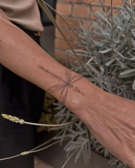 Fine Line dragonfly tattoo design for women on forearm and wrist