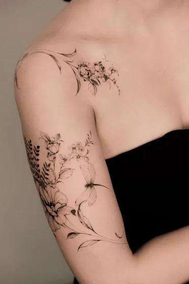 Fine Line floral dragonfly tattoo for women on shoulder.