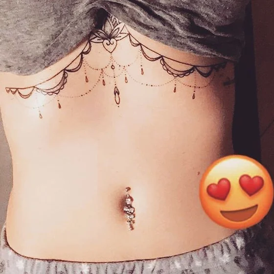 Fine Line floral heart tattoo design for women on sternum and rib