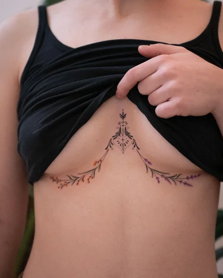 Fine Line floral ornamental tattoo design for women on sternum