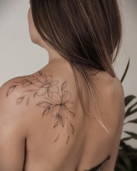 Fine Line floral tattoo design for women on shoulder and back