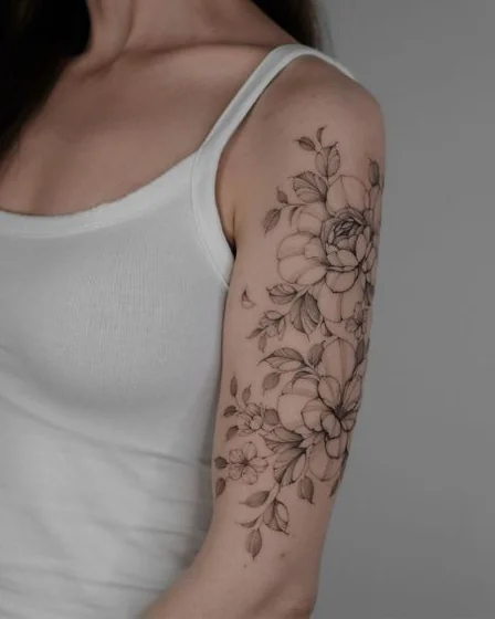 Fine Line floral tattoo design for women on upper arm