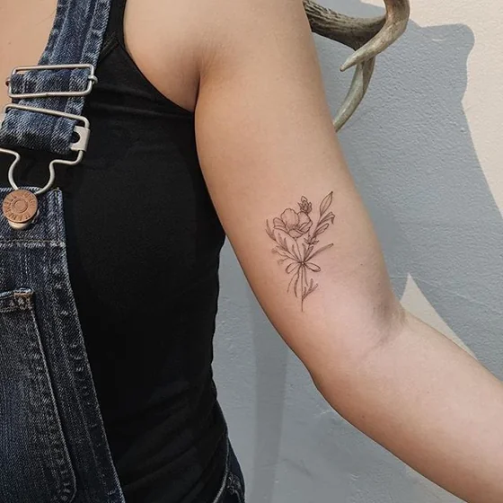 Fine Line floral tattoo design for women on upper arm