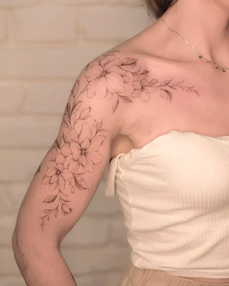 Fine Line floral tattoo for women on shoulder and upper arm