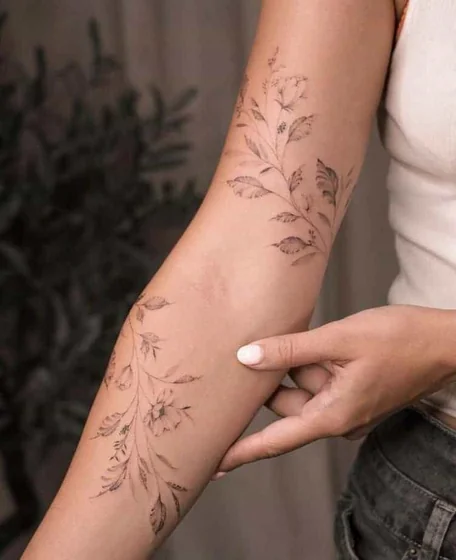 Fine Line floral vine tattoo design for women on forearm