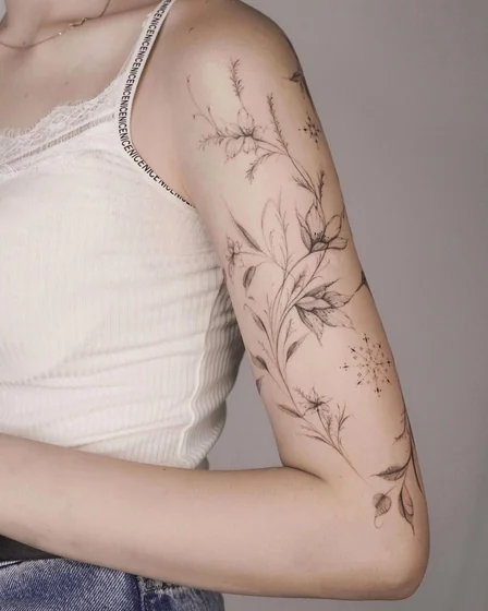 Fine Line floral vine tattoo design for women on upper arm and shoulder