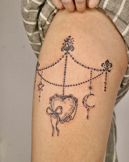 Fine Line heart, star, and moon tattoo design for women on thigh