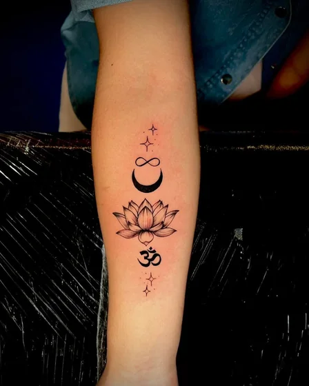 Fine Line minimalist Lotus, Moon, Infinity, and Om tattoo design on forearm