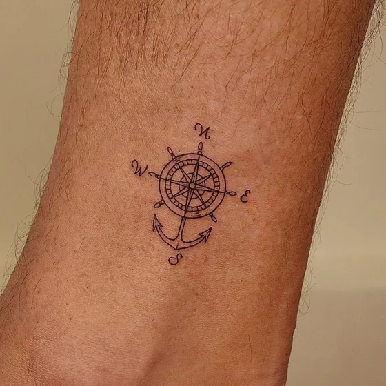 Fine Line minimalist compass and anchor tattoo design for men on wrist