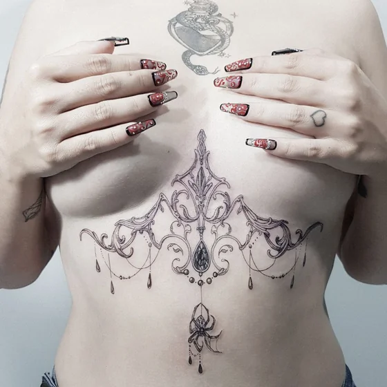 Fine Line ornamental spider and snake patchwork tattoo for ladies on sternum