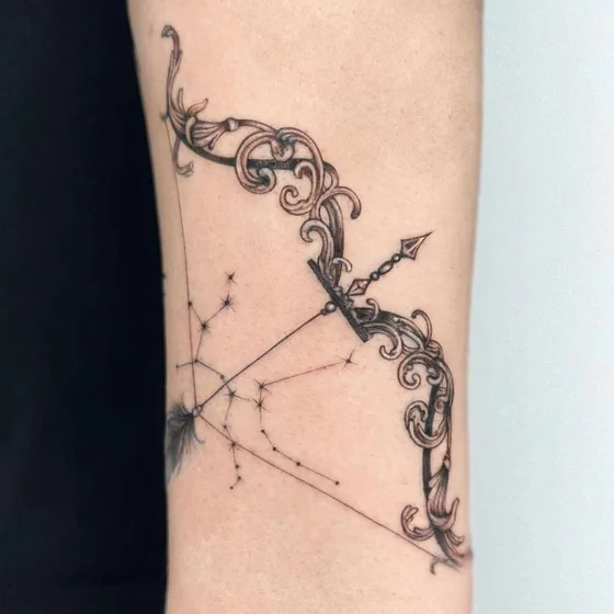 Fine Line ornate bow & Sagittarius stars tattoo for women.