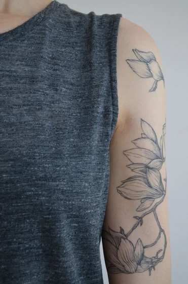 Fine Line sketch floral tattoo idea for women on upper arm