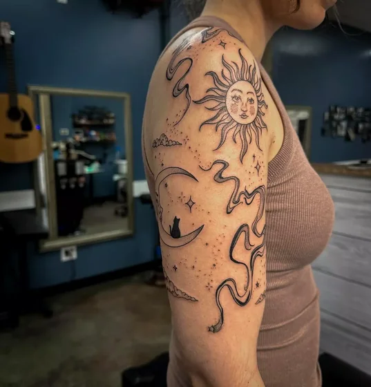 Fine Line sun, moon, cat tattoo idea for women on shoulder and upper arm.