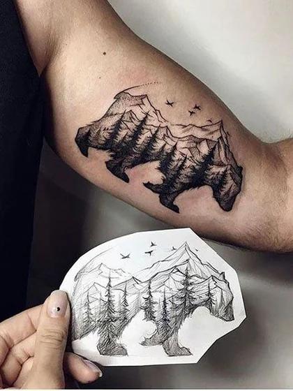 Fine line bear mountain bird tattoo design for men on upper arm