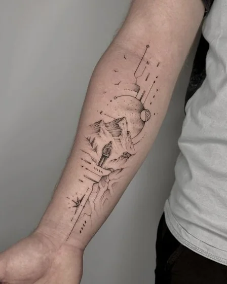 Fine line minimalist mountain, moon, compass tattoo design for men on forearm