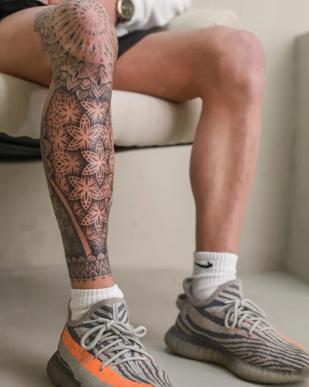 Geometric Dotwork Floral tattoo idea for men on leg and knee