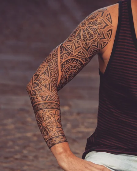Geometric Dotwork full sleeve tattoo idea for men, mandala patterns.
