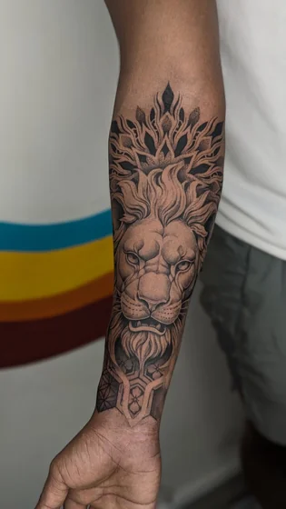 Geometric Lion and Floral Mandala tattoo idea for men on forearm.