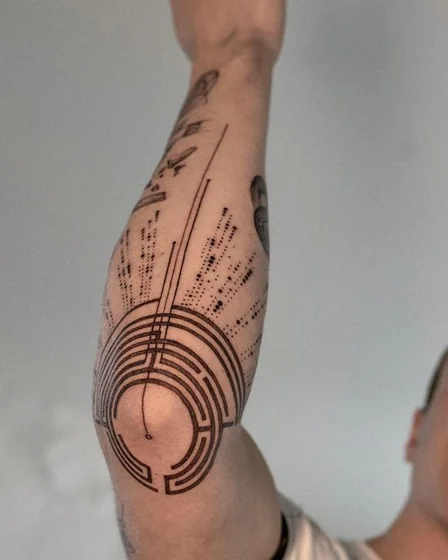 Geometric and Dotwork Labyrinth tattoo design for men on elbow and upper arm