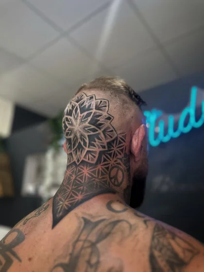 Geometric blackwork mandala peace sign tattoo for men on neck and back