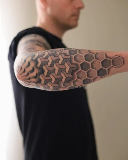 Geometric dotwork 3D pattern tattoo for men on forearm and elbow
