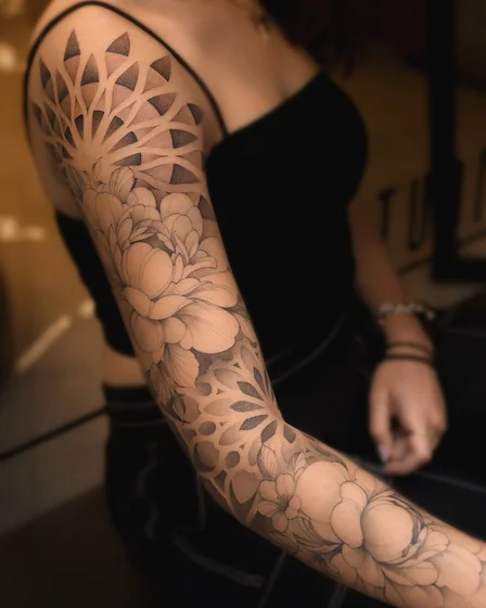 Geometric dotwork floral half sleeve tattoo for ladies on shoulder