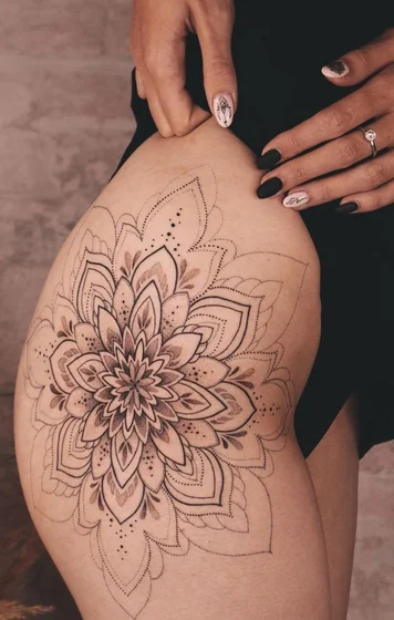 Geometric dotwork floral tattoo design for women on thigh