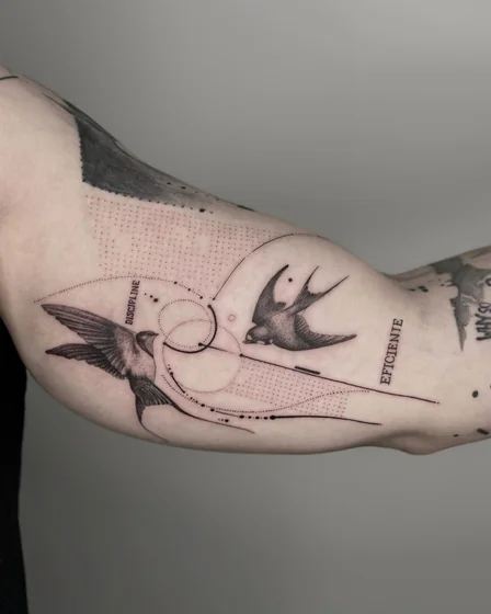 Geometric fine line bird and word tattoo design for men on upper arm