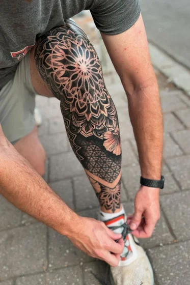 Geometric mandala and floral tattoo design for men on knee and leg
