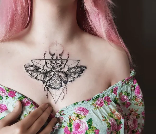 Geometric sketch beetle tattoo design for women on sternum