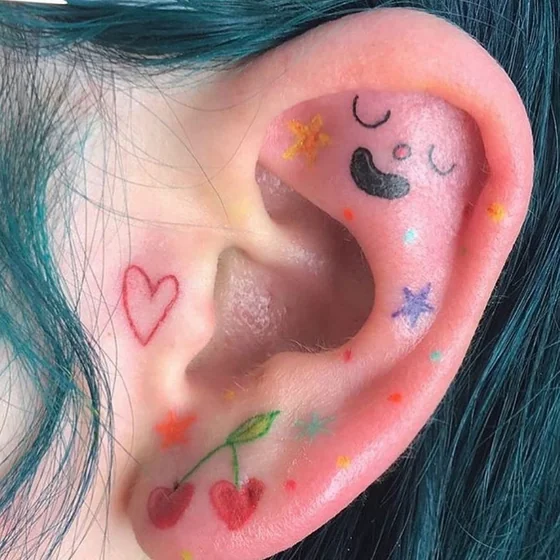 Ignorant patchwork heart, star, moon, cherry tattoo on ear for women