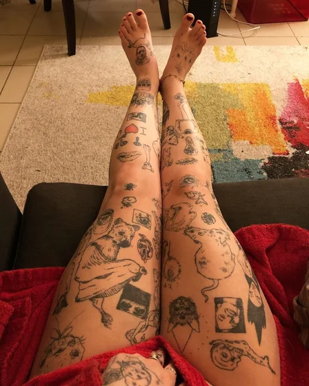 Ignorant patchwork tattoo idea with heart, skull, cat for women on legs.
