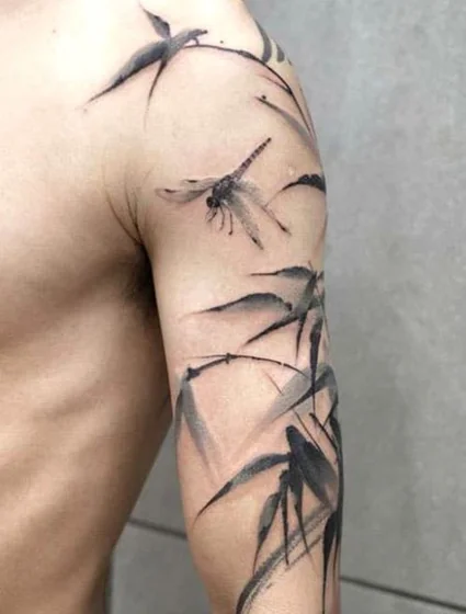 Ink wash watercolor dragonfly & bamboo tattoo for men on arm
