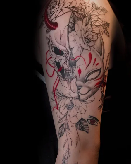 Japanese Neo-Traditional skull, Kitsune mask, floral tattoo idea for women on upper arm.