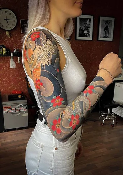 Japanese dragon and floral full sleeve tattoo design for women on arm