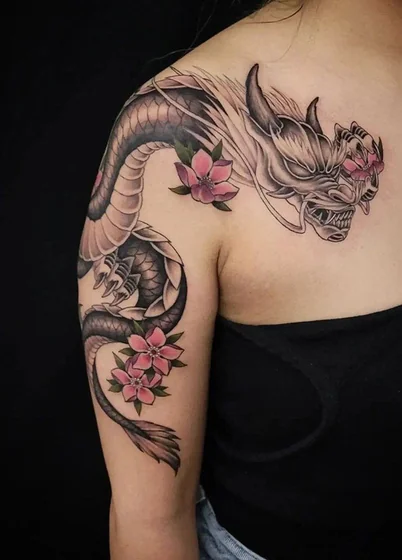 Japanese dragon and floral tattoo for women on shoulder and arm