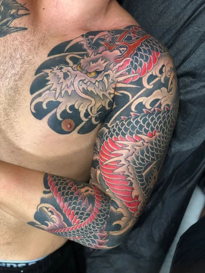 Japanese dragon and waves tattoo design for men on half sleeve and chest