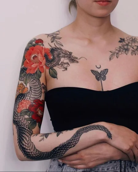 Japanese dragon & floral tattoo idea for women on arm & shoulder