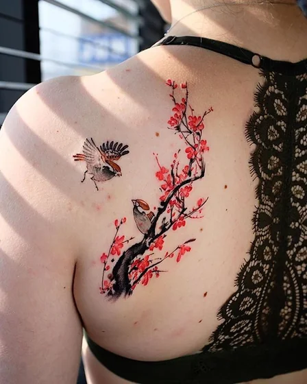 Japanese linework bird and floral tattoo for women on shoulder