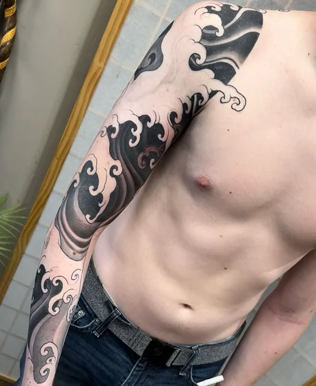 Japanese ocean waves full sleeve tattoo idea for men.