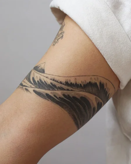 Japanese patchwork ocean and mountain tattoo design for women on upper arm