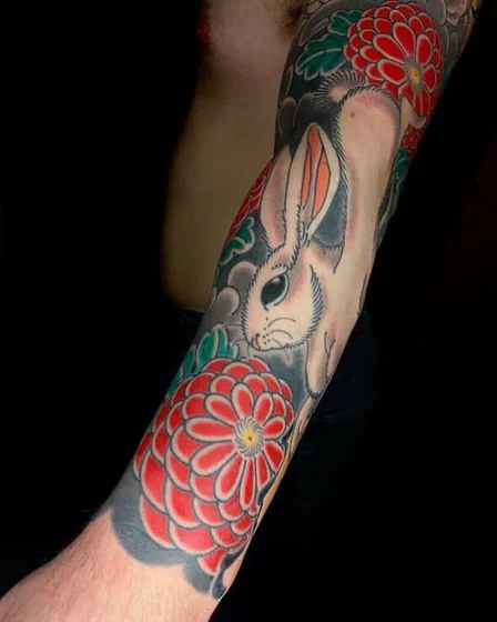 Japanese rabbit and floral half sleeve tattoo for men