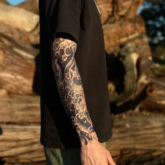 Japanese style flower and ocean half sleeve tattoo idea for men