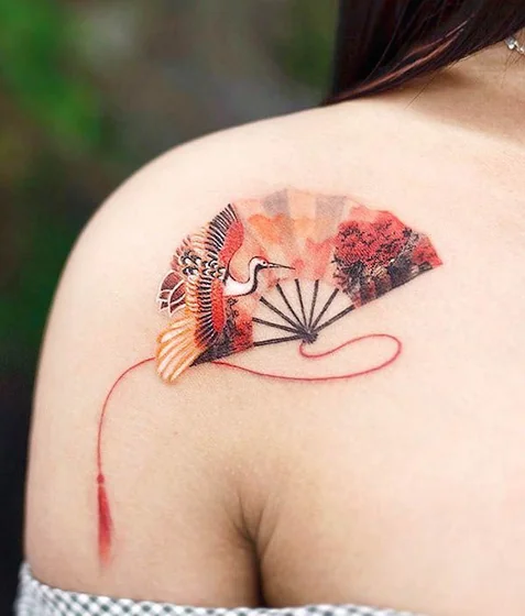 Japanese watercolor fan and crane tattoo for women on shoulder