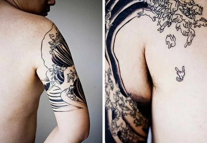 Japanese wave and rabbit linework tattoo design for men on upper arm